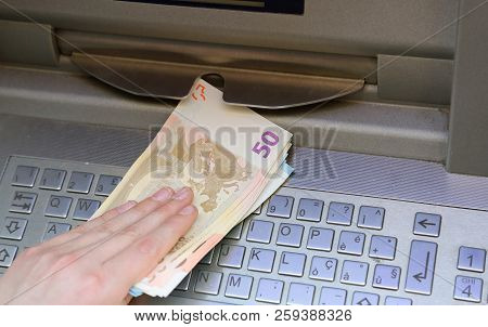 Much Money At An European Atm And The Hand Of A Boy