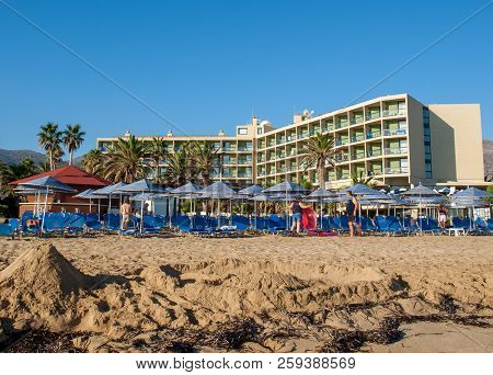 Malia. Crete, Greece - July 1, 2018: Sunbeds At The Beach In Malia On Crete, Greece