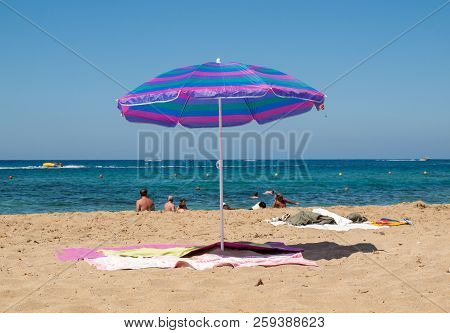 Malia. Crete, Greece - July 1, 2018: People Are Resting On A Sunny Day At The Beach In Malia, Crete,
