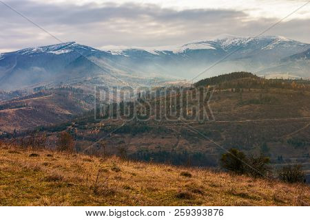 Gloomy November Scenery In Mountains. Foggy And Hazy Forenoon On An Overcast Day. Distant Mountain T