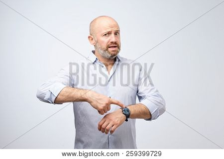 Mature European Businessman Impatiently Pointing To His Watch. Why Are You Late Concept.