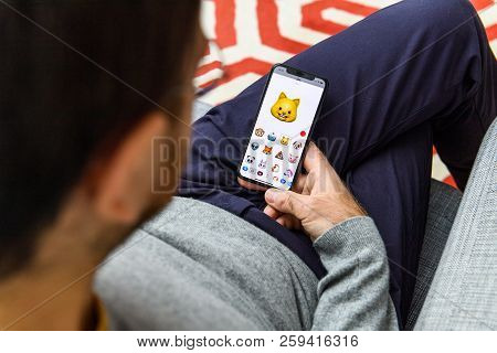 London, Uk - Sep 21, 2018: Man Using The New Cat Ar Memoji Emoji On Apple Iphone Xs Face With The Im