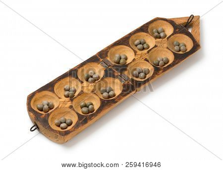 Traditional African oware game with seeds isolated on white background