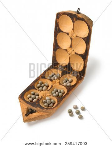 Traditional African oware game with seeds isolated on white background