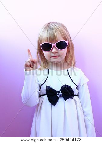 Beautiful Girl Threatening Finger. Young Serious Girl Shaking Her Finger. Little Girl In Sun Glasses