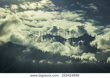 Silhouettes Of Trees On The Mountain And Dark Sky