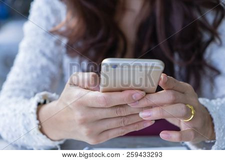 Close Up Female Hands Holding Using Mobile Smart Phone.
Business Woman Typing Text Messages On Touch