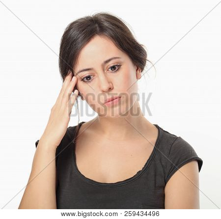 Upset Young Brunette Holding Hand At Head