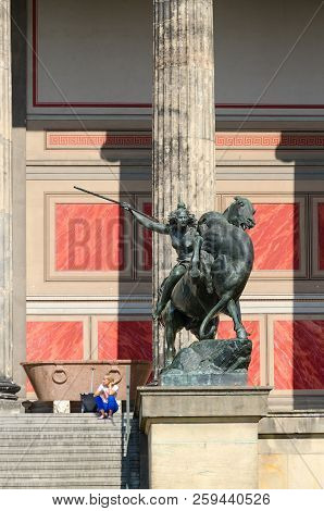 Berlin, Germany - September 5, 2018: Unknown Woman-tourist Is Sitting On Steps Of Old Museum On Famo
