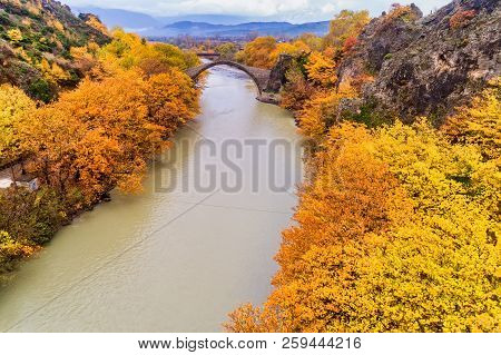 Aerial View Of Konitsa Old Bridge And Aoos River An Autumn Day, Greece.