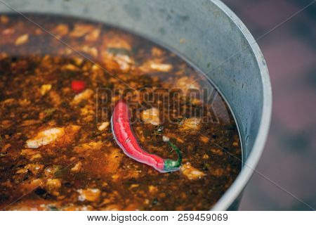 Gulyas Stew Boiling In A Cauldron. Street Food