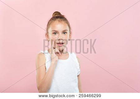 Speechless Dumbstruck Shocked Little Girl. Portrait Of A Young Cute Child On Pink Background. Emotio