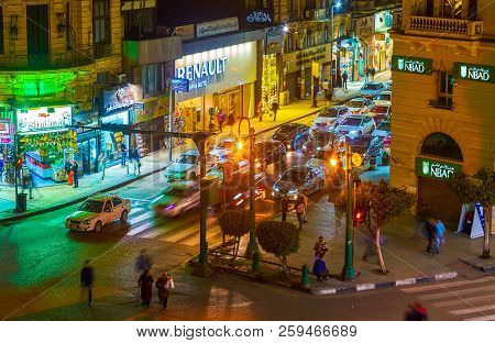 Cairo, Egypt - December 23, 2017: The Cars At The Crosswalk Of Talaat Harb Square With A View On Fas