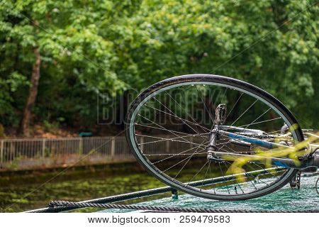 Wheel Of A Bicycle Tied On The Roof Of A Boat In A Canal Near Islington Tunnel In Angel, Uk