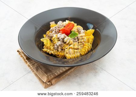 Radiatori pasta in a creamy tomato parmesan cheese sauce