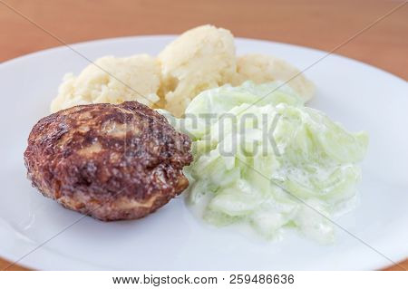 Polish Meatballs Knows In Poland As Kotlet Mielony With Mizeria And Mashed Potatoes.
