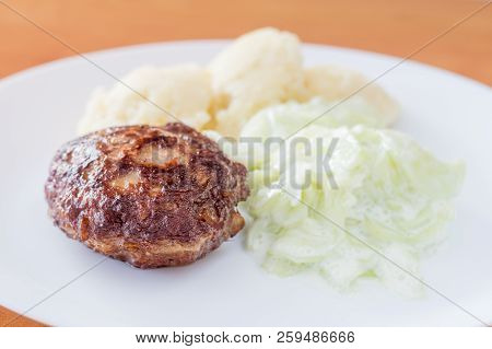 Polish Kotlet Mielony (meatballs) With Mizeria And Mashed Potatoes.