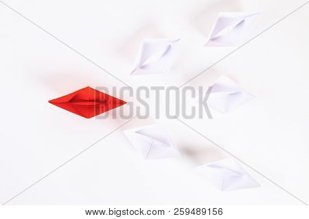 Red Paper Boat Among Other White. Leadership, White Crow, Individuality. Piranhas And A Shark. Not L