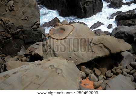 Rope And Rock At The Udo Jingu - Shinto Shrine Located In Miyazaki, Japan. People Throw Coins Into T