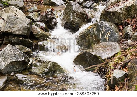 Autumn Waterfall With Rocks And Leaves In Troodos Mountains In Cyprus