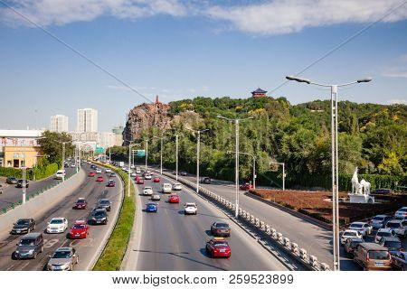 URUMQI, XINJIANG, CHINA - AUG 31, 2017:  Hong Shan (Hongshan or Red Mountain) Park as seen from Xi Daqiao Bridge over busy Hetan North Road