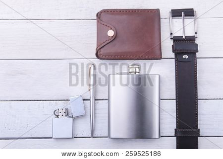 Gadgets And Accessories For Men On Light Wooden Background. Fashionable Men S Belt, Wallet, Lighter,