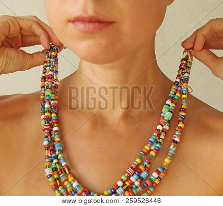 Bright Beads Of Murano Glass On A Young Girl. A Girl Dresses And Button Beads, Jewelry