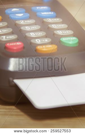 Pos Payment Terminal On Wooden Background. Credit Card Terminal, Eftpos Terminal