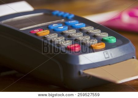 Pos Payment Terminal On Wooden Background. Credit Card Terminal, Eftpos Terminal