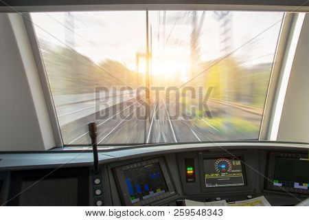 Driver's Cab Of Aspeed Passenger Train, View Of The Railway With The Effect Of Speed Motion Blur.