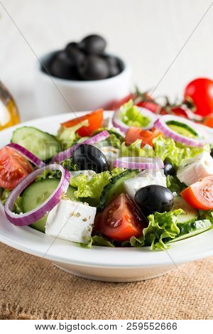 Fresh Greek Salad Made Of Cherry Tomato, Ruccola, Arugula, Feta, Olives, Cucumbers, Onion And Spices