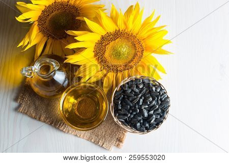Sunflower Oil And Sunflower Seeds In Small Sack On Traditional Rustic Wooden Background. Organic And