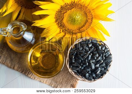 Sunflower Oil And Sunflower Seeds In Small Sack On Traditional Rustic Wooden Background. Organic And