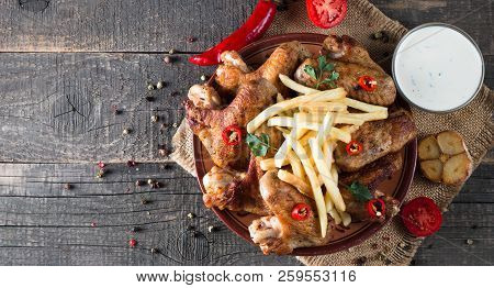 Close-up Photo Of Bbq Chicken Wings With Fries And Beer. Barbeques Meat With Sauces, Ketchup, Mayonn