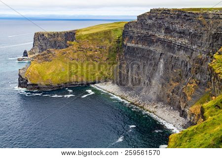 People Walking Over Cliffs Of Moher