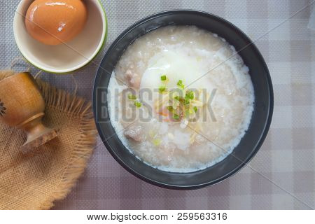Rice Porridge Or Congee With Pork Egg Sliced Ginger And Vegetable. Delicious Breakfast