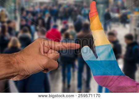 Finger Pointing To A Peaceful Hand With Pride Flag