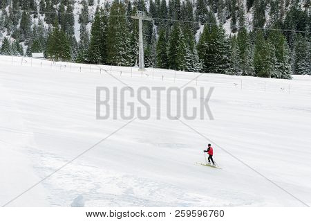 Minimal Style Winter Landscape With Ski Slope Full Of Snow, Surrounded By Snowy Fir Trees, And A Sin