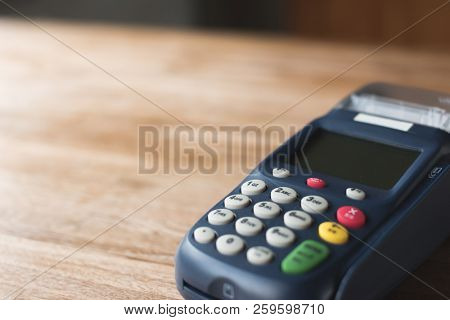 credit card machine on the wooden table with nobody
