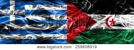 Greece Vs Sahrawi Smoke Flags Placed Side By Side. Thick Colored Silky Smoke Flags Of Greek And Sahr