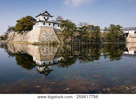 Traditional Japanese Samurai Castle Reflected In Water In Imabari, Ehime Prefecture, Japan