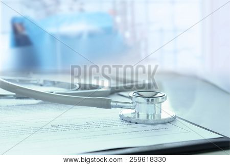Medical Concept. Stethoscope And Medical Form On Desk Of Doctor In Hospital.