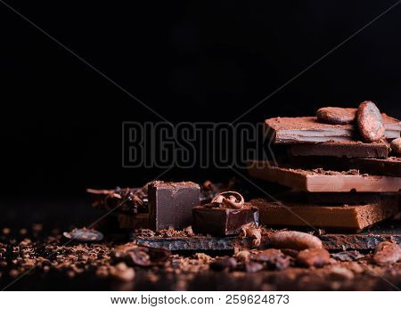 Chocolate Bars On Table With Chocolate Tower. Chocolate And Nuts And Choco Swirl