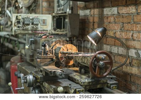 Old Machinery In A Factory From The Mid-20th C. Working Machine-tool. Old Lathe.