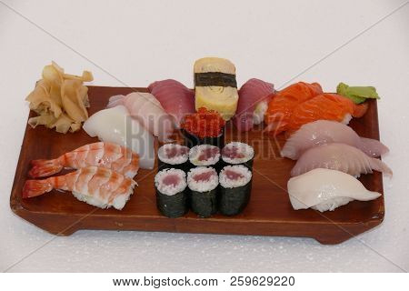 Sushi California Philly Rolls Appetizer With Rice Avocado And Salmon On Square Blue Plate W/ Chopsti