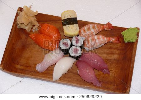 Sushi California Philly Rolls Appetizer With Rice Avocado And Salmon On Square Blue Plate W/ Chopsti
