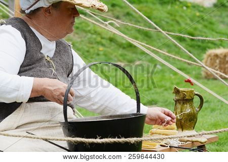 Woman In Medieval Clothes Makes Candles