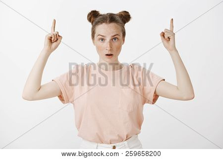 Shocked Impressed Cute Caucasian Woman With Freckles And Two Buns Hairstyle, Dropping Jaw And Starin