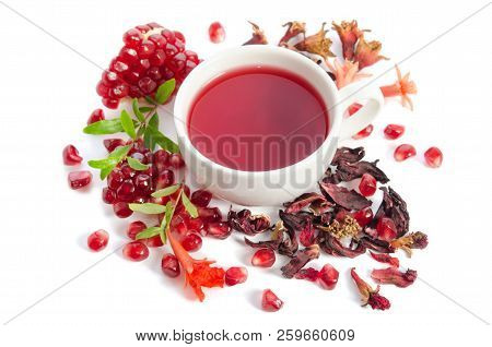 Parts Of A Pomegranate With Pomegranate Seeds And Leaves, Flowers, Dry Tea Of Carcade And Full Cup O