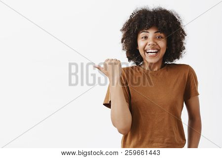 Waist-up Shot Of Surprised Pleased And Impressed Happy Attractive Dark-skinned Female In Brown T-shr
